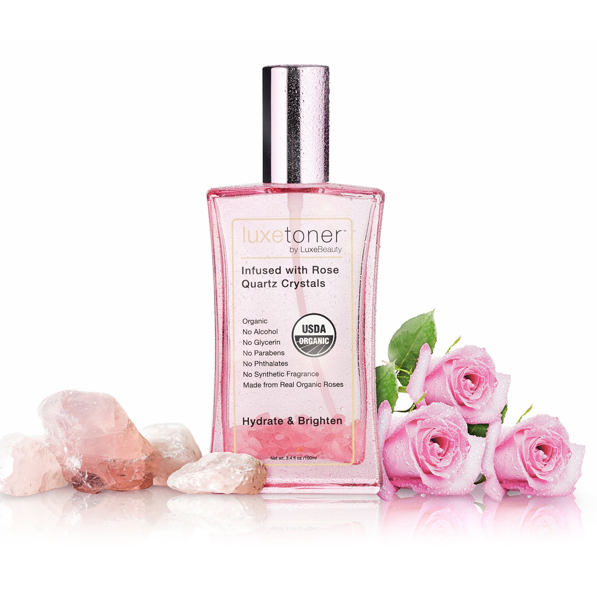 Luxe Toner bottle with pink roses and crystals on a white background