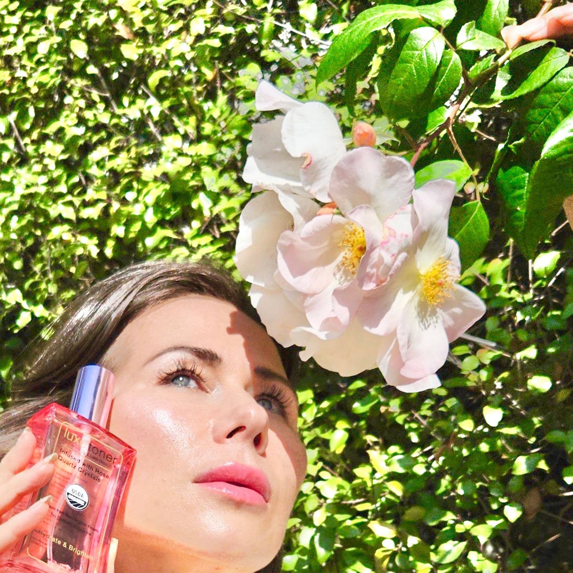 Jane May Graves applying Luxe Toner with a floral background