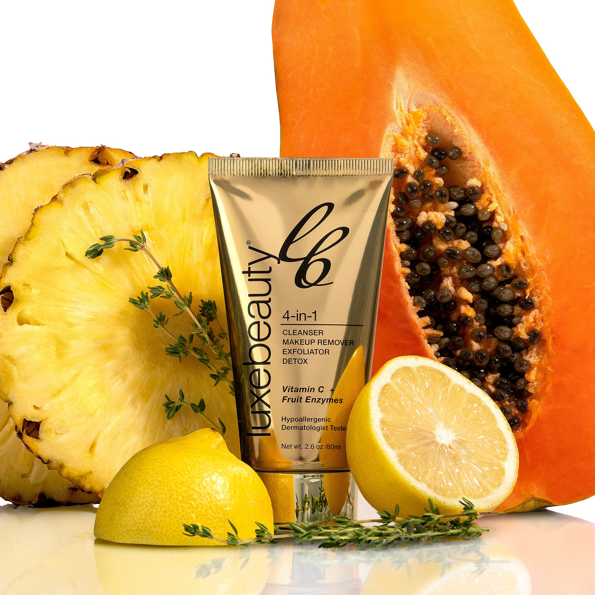 Tube of Luxe Beauty skincare product with a pineapple, lemon, and papaya on a white background