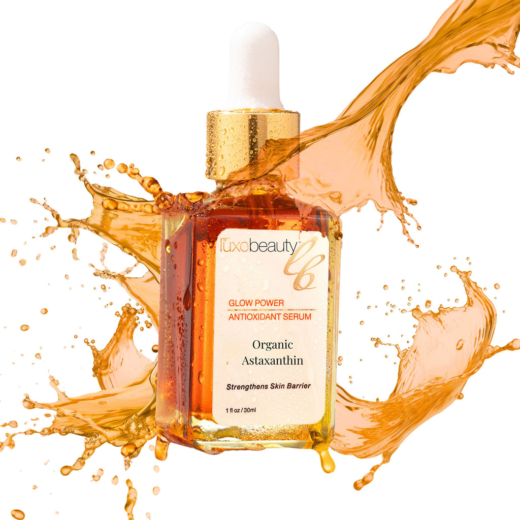 Luxe Beauty serum bottle with splashes of liquid on a white background