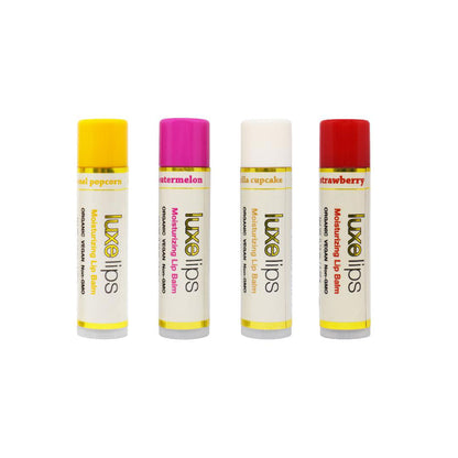 Four Luxe Lips balms in Caramel Popcorn, Watermelon, Vanilla &amp; Strawberry flavors on a white background