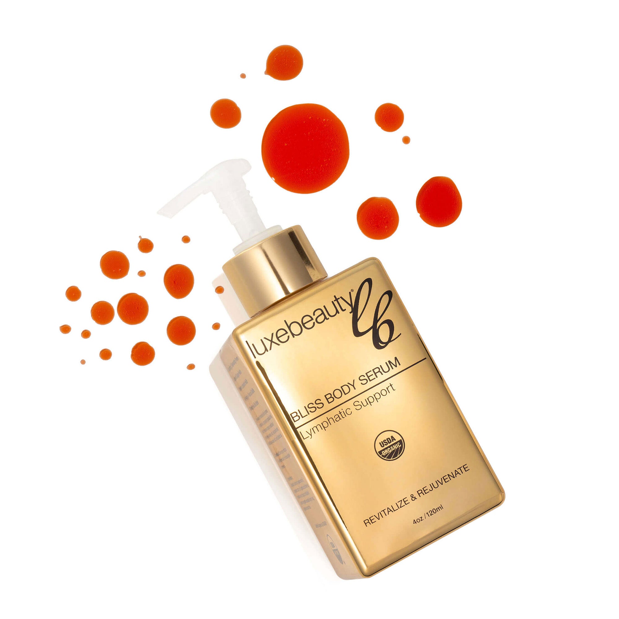 Gold bottle of Luxe Beauty bliss body serum with red droplets on a white background