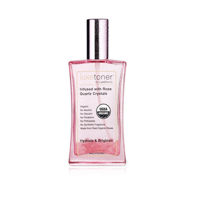Luxe Toner bottle with pink liquid on a white background